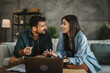 © Miljan Živković - Adult couple girlfriend and boyfriend work from home on laptop