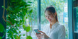 © GraysonStock - A young Asian woman using her smartphone in a modern office.