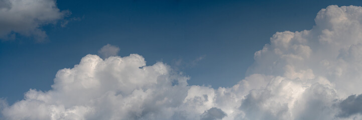 Wall Mural - panorama of beautiful white summer clouds in a blue sky. cumulus puffy clouds.