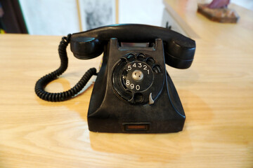 Antique black phone with rotary dialing system