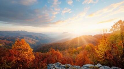 Aufkleber - A beautiful mountain view with a bright orange sun shining on the trees. The sky is clear and the mountains are covered in autumn foliage