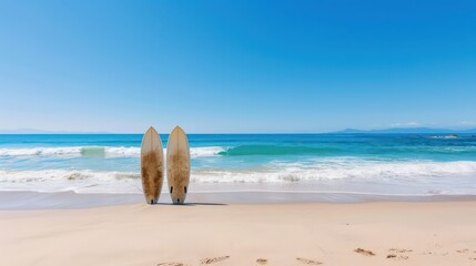 Aufkleber - Two surfboards are laying on the beach, one on the left and one on the right. The beach is empty and the sky is clear