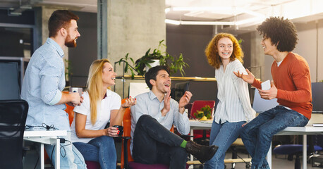 friendship at workplace. diverse millennial people having good talk at coworking space, panorama