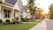 © LifeMedia - A beautiful suburban neighborhood street features cozy, charming homes, green lawns, and trees basking in warm sunset light, offering a peaceful, idyllic ambiance.