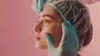 © Marco - person touching the face of a woman with a hat on a pink background. plastic surgery or operation concept