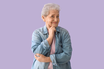 Wall Mural - Thoughtful senior woman on lilac background