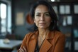 © Baba Images - Portrait of a middle aged female worker in startup company office