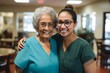 © Baba Images - Portrait of a smiling senior woman with caregiver in nursing home