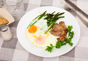 Wall Mural - Vibrant breakfast of delicate roasted rabbit liver paired with perfectly fried eggs and asparagus, garnished with fresh parsley