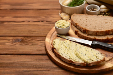 Wall Mural - Board with bread slices and bowl of fresh butter on wooden background