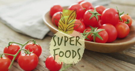 Wall Mural - Super foods text image over fresh tomatoes on wooden table