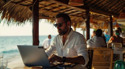 A person sitting at a table with a laptop, possibly working or browsing