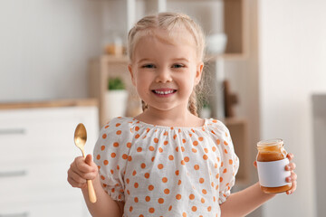 Canvas Print - Happy little girl with spoon and jar of jam at home