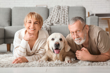 Canvas Print - Mature couple with Labrador dog lying on floor at home