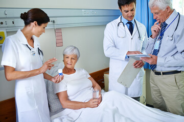 Poster - Hospital, pills and doctors with old woman, explaining or communication for health of patient or medical. Clinic, wellness and nurse with senior person, water or medicine in appointment of healthcare