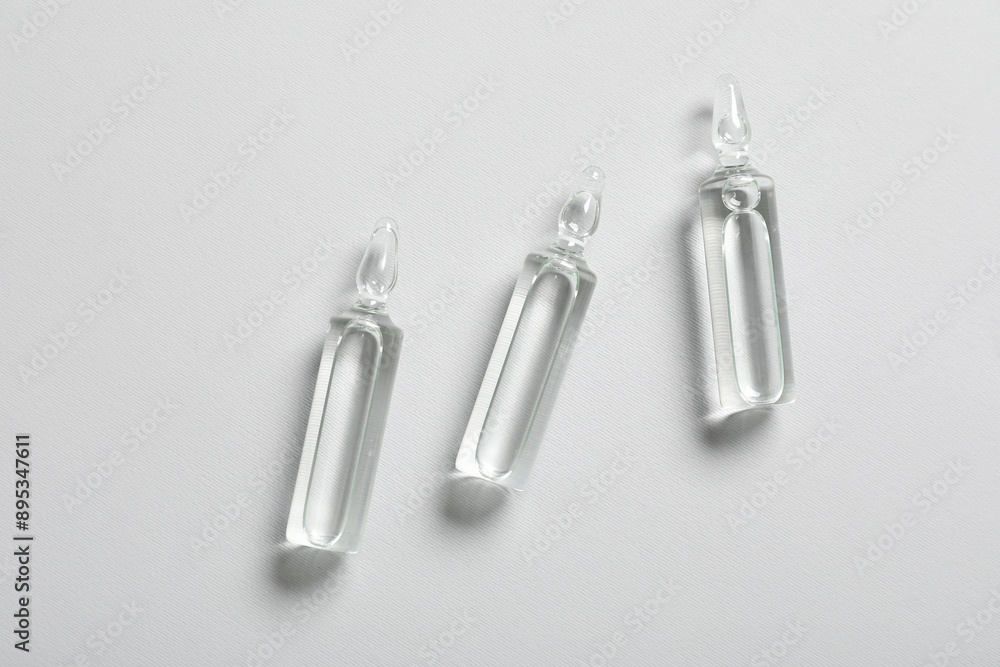 Glass ampules on grey background