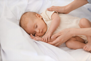 Poster - Mother with her sleeping little baby on bed, closeup