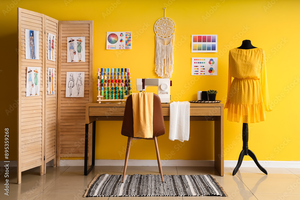 Interior of atelier with tailor's workplace, mannequin and folding screen