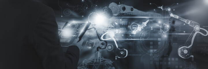 Wall Mural - industry engineer in factory,using smart tablet glass device,control automated robot arm machine lea