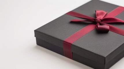 Poster - A black box with red ribbon on top