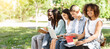 © Prostock-studio - Group of students studying together outdoors, preparing for lectures and classes while sitting on bench in campus, black girl smiling at camera