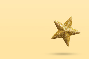 Wall Mural - golden Christmas star glitter sticker isolated on yellow background