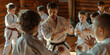 © Aigo labs - caucasian group of children in karate uniform training with a sensei in a dojo.
