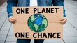© ahmed elmaslamani - Environmental Activist Holding a 'One Planet One Chance' Sign