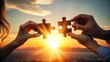 © thanakrit - Two Hands Holding Puzzle Pieces at Sunset.