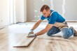 © Daria - Precise installation  skilled man installing laminate floor boards with care in a photography shot