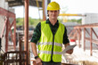 © Poguz.P - Engineer man in hardhat working at construction site, Foreman worker with digital tablet on a construction site