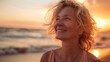 © Thanos - Mature Woman Breathing Ocean Air on Beach at Sunset, Smiling and Happy