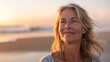 © Thanos - Mature Woman Breathing Ocean Air on Beach at Sunset, Smiling and Happy