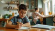 © ibooM - A boy with a school backpack is sitting at the kitchen table doing his homework, while his mother is preparing dinner.