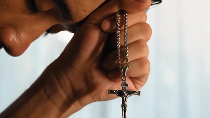 Wall Mural - Sense of devotion and spiritual fulfill with christian catholic follower immerse in faith. Slow motion christian holding holy cross while praying to worship the god. Burgeoning