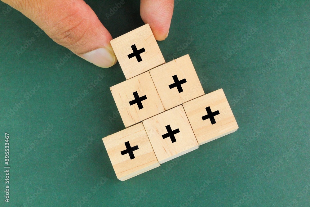 Increasing Plus plus signs are stacked up. Added value or increasing benefits concept ...