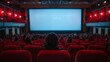 © pornsawan - People in the cinema auditorium with Cinema blank wide screen and red chairs in the cinema hall,People silhouettes watching movie performance,empty white screen,space for text.