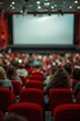 © pornsawan - People in the cinema auditorium with Cinema blank wide screen and red chairs in the cinema hall,People silhouettes watching movie performance,empty white screen,space for text.