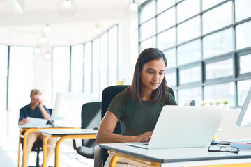 Wall Mural - Design, office and woman at laptop in coworking space for web report, growth and planning ideas. Research, typing and creative professional at desk for online project development at digital agency