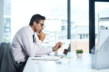 Wall Mural - Accounting, laptop and review with financial advisor man at desk in office for decision or planning. Computer, reading and thinking with accountant or bookkeeper in workplace for portfolio management