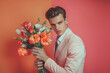 © Yana Zolotova - Young Man Holding Vibrant Flower Bouquet in Front of Colorful Background