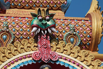 Wall Mural - Head of Kirtimukha on the dome of a Hindu temple.