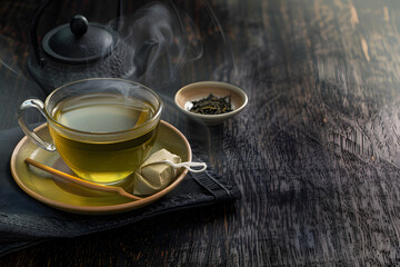 Wall Mural - Brew a cup of green tea with bag, hot drink with steam