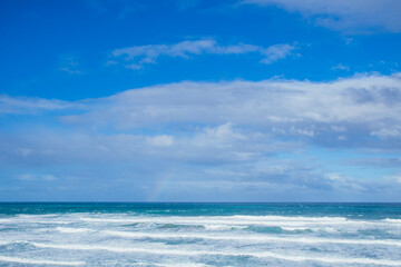 Blue landscape with rainbow