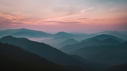 pastel sunset over layered mountain range. soft pastel hues of sunset illuminate a layered mountain 