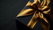 © nekokawaodori - 高級感のある金色のリボンと黒いギフトボックス。コピーまたはテキスト用のスペースがある黒い背景画像
