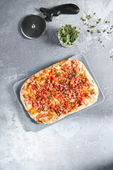 Wall Mural - Delicious Roman Tuna Tartare Pizza with Fresh Tomatoes on a Grey Background