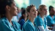 © okfoto - Diverse doctors and nurses in scrubs and stethoscopes listen attentively at a medical conference, focusing on professional development and collaboration.