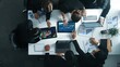 © InfiniteFlow - Top view of smart business people brainstorm marketing idea at meeting table while compare stock market investment data between laptop and tablet. Business team planning financial plan. Directorate.
