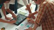 © Summit Art Creations - Close up of smart business team hand working together to plan design while looking at project plan from tablet and discussing about blueprint and building construction at meeting table. Alimentation.